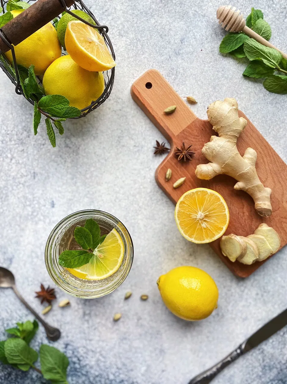 Ginger, lemon and mint arranged on a board